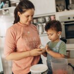Parent and toddler preparing food together at the kitchen counter, the setting where toddlers use learning towers