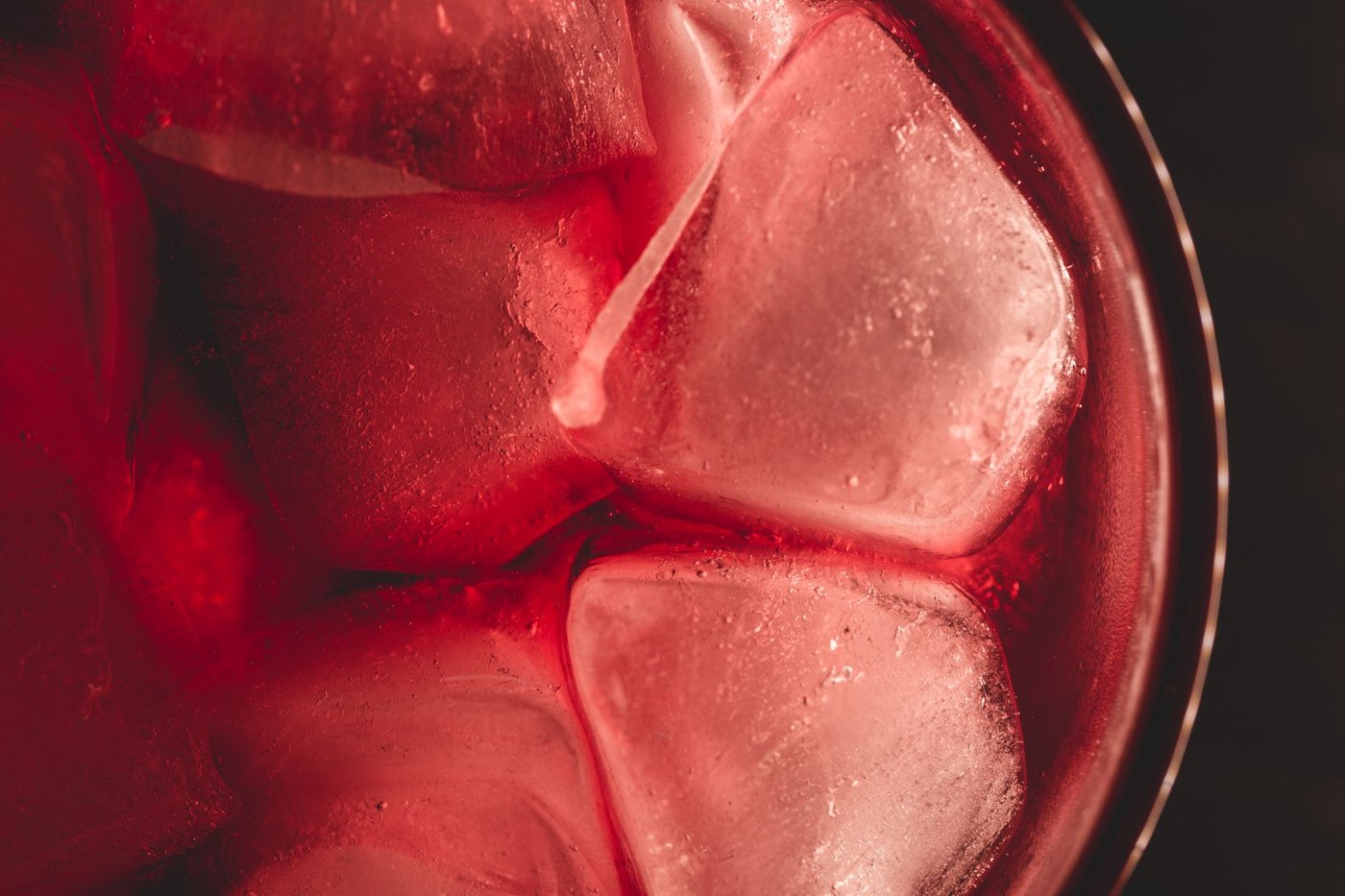 Glass filled with fresh ice cubes, the kind of small clear ice a countertop bullet ice maker produces