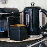 Black coffee maker and kettle on a compact modern kitchen countertop