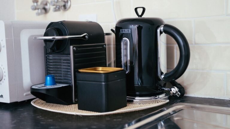 Black coffee maker and kettle on a compact modern kitchen countertop