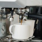 Automatic espresso machine pouring fresh coffee into a ceramic mug at home