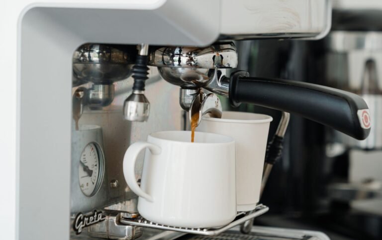 Automatic espresso machine pouring fresh coffee into a ceramic mug at home