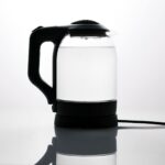 Glass electric kettle boiling water on a countertop, a safe alternative to recalled Lakkzoom immersion water heaters
