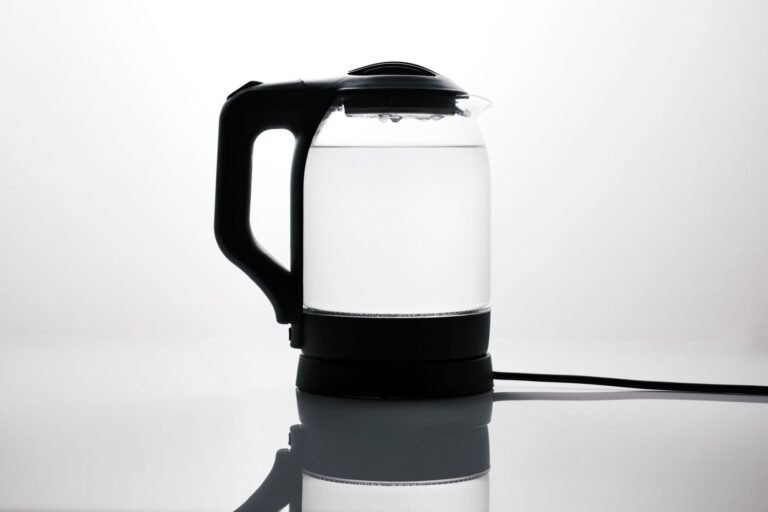 Glass electric kettle boiling water on a countertop, a safe alternative to recalled Lakkzoom immersion water heaters