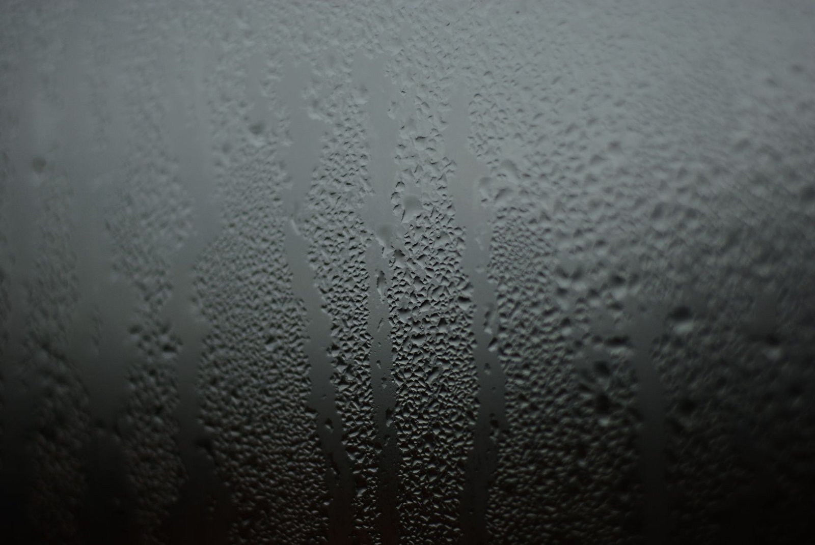 Condensation on a window pane signaling high indoor humidity