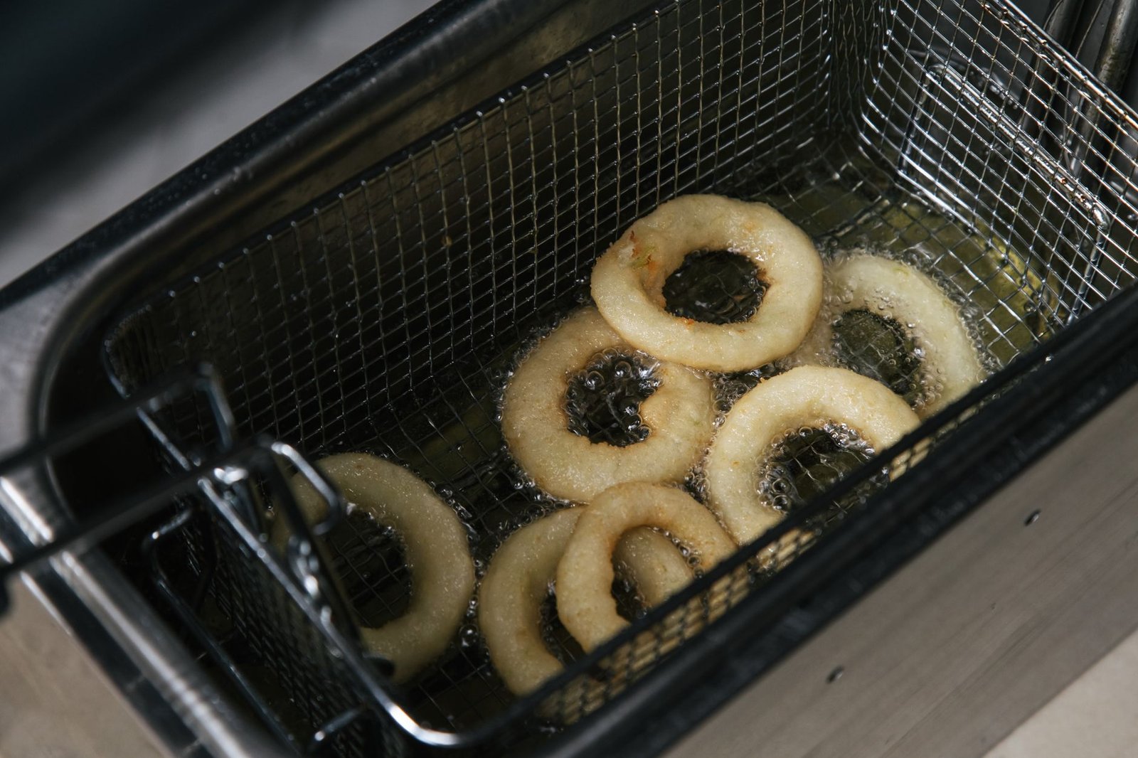 Air fryer basket with food on a kitchen counter