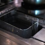 Empty air fryer basket ready for cleaning