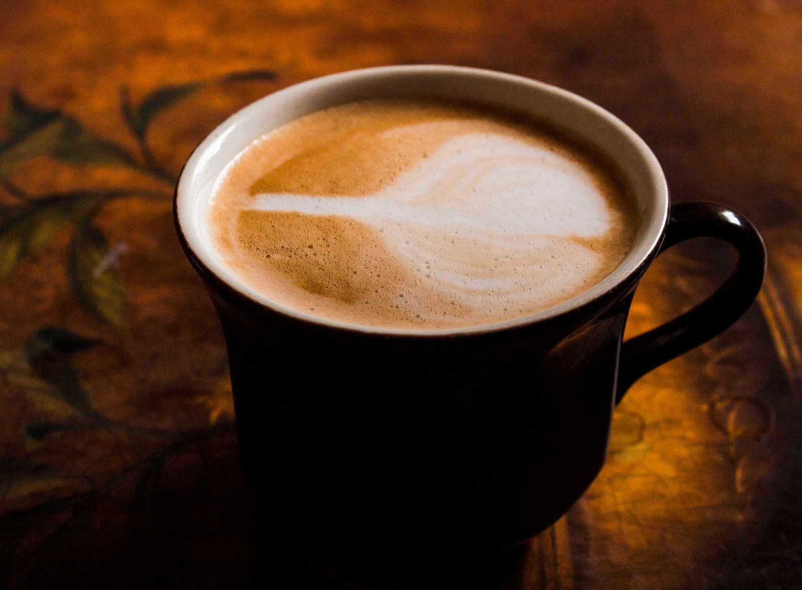 Cappuccino with cold foam and latte art made by an automatic espresso machine