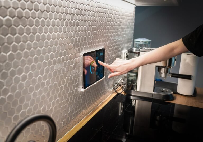 A large touchscreen smart home display panel in a modern kitchen like the Cozyla Calendar+ Go