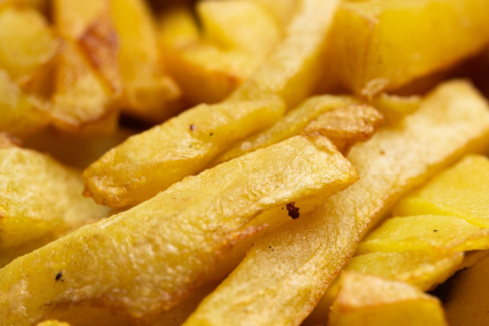 Golden crispy air-fried french fries made in a countertop air fryer toaster oven
