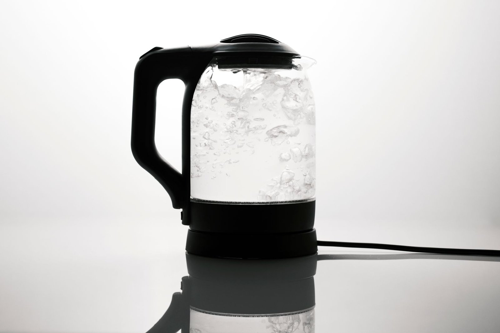 Electric kettle boiling water safely on a kitchen counter