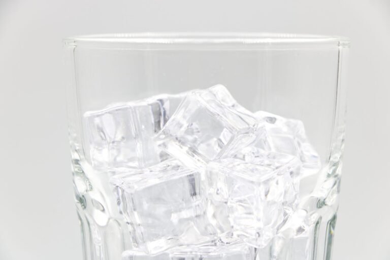 Glass filled with fresh bullet ice cubes from a countertop ice maker