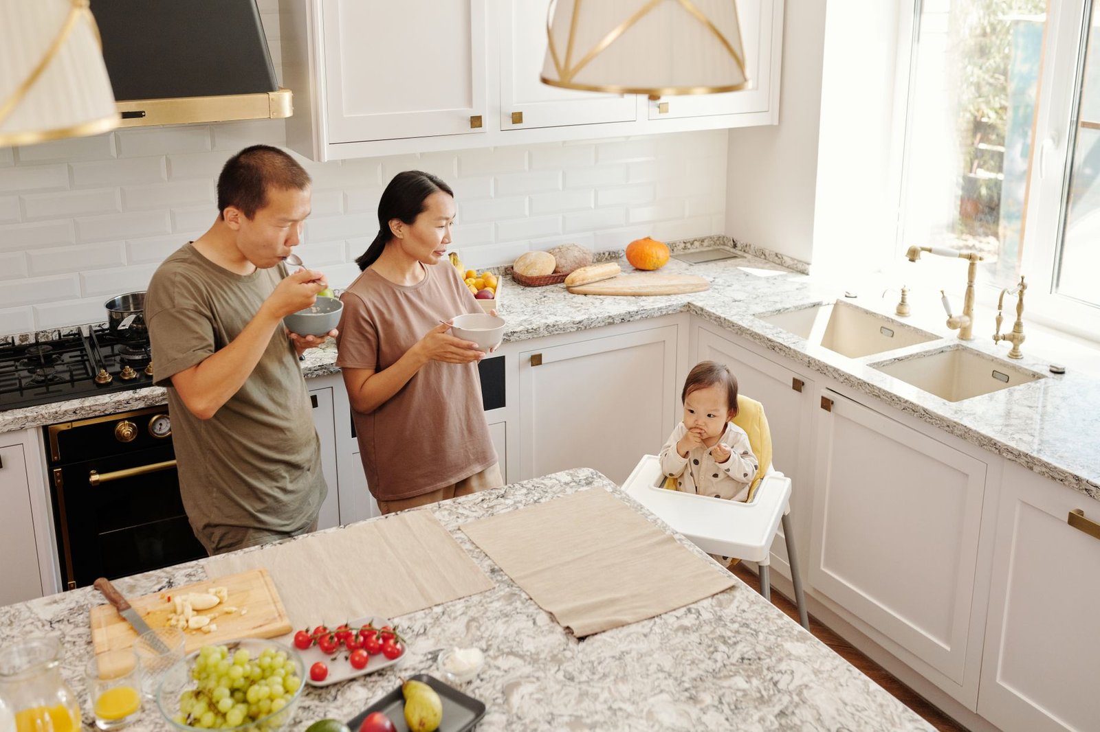 A family sharing breakfast in a cozy kitchen where a shared digital calendar keeps everyone organized