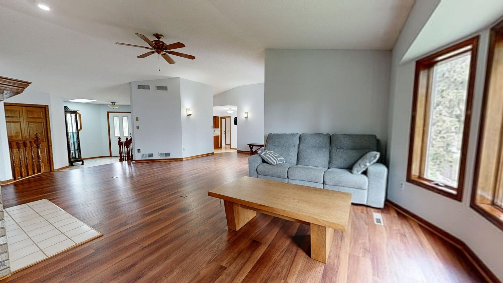 Bright modern living room with clean hardwood floors kept tidy by a robot vacuum