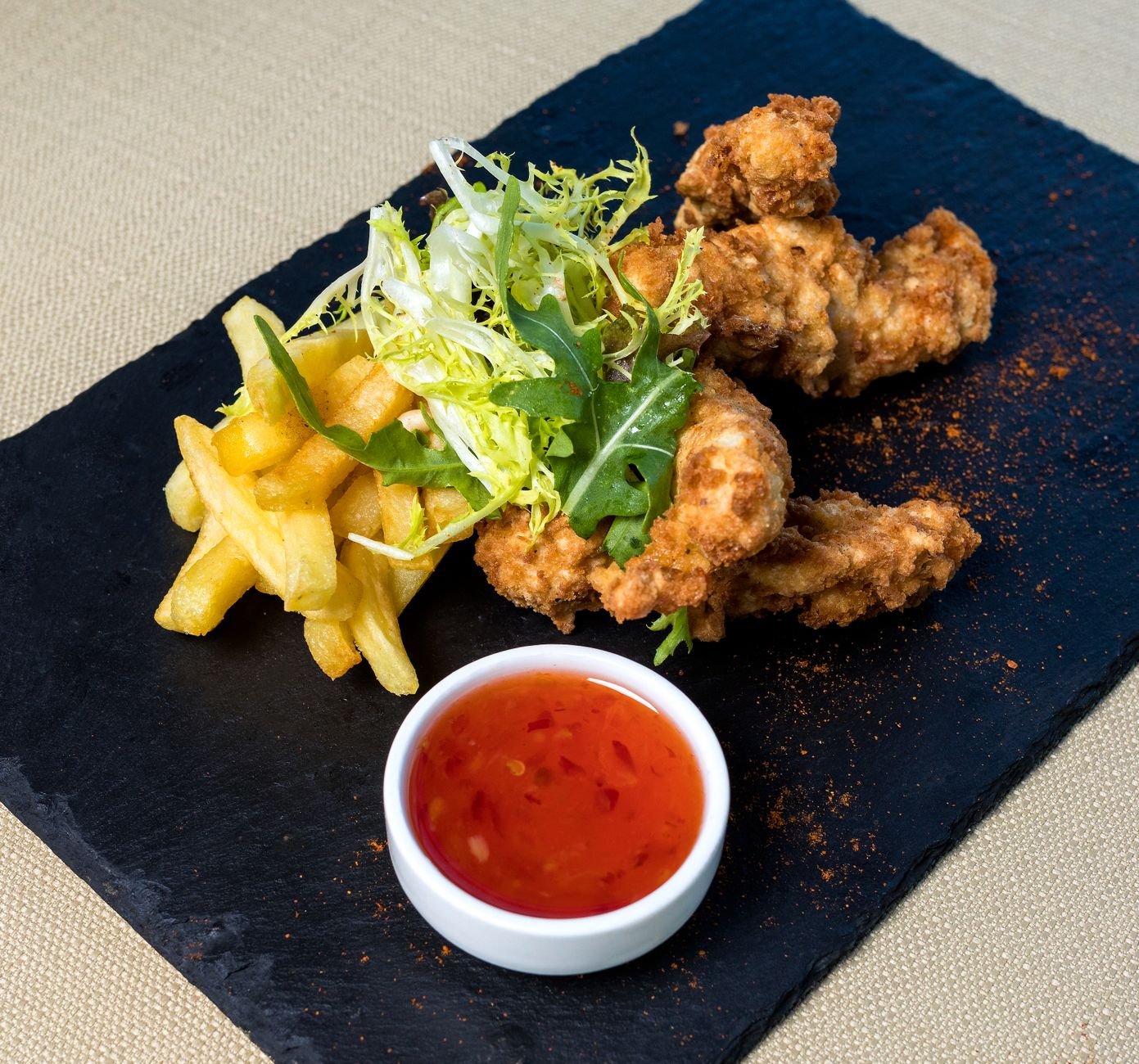 Plate of crispy air-fried chicken and fries like results from the Ninja Crispi air fryer