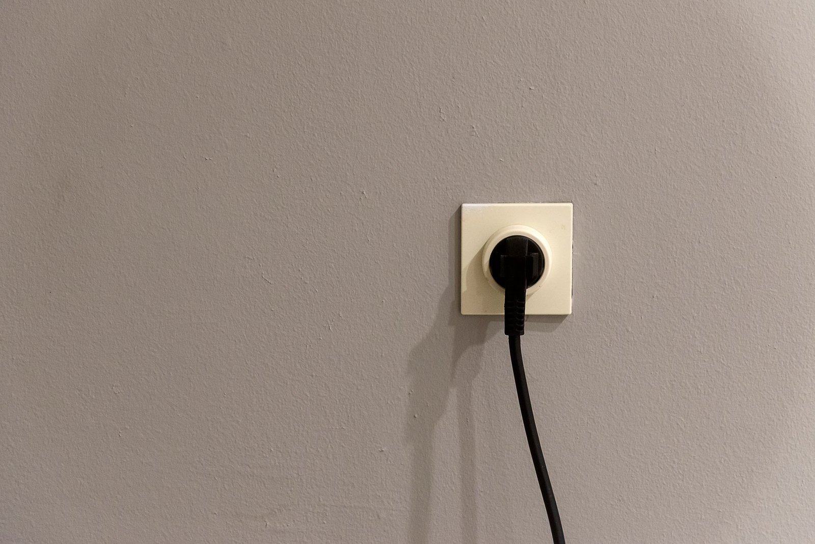 A plug inserted into a wall socket