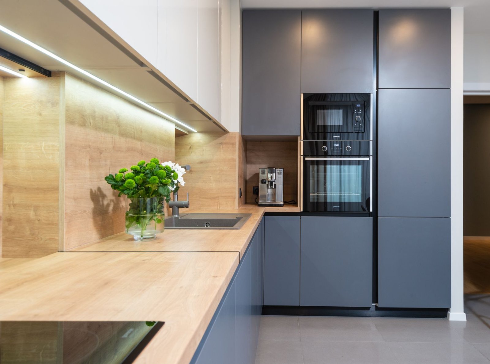 Modern kitchen countertop with a compact voice-controlled air fryer and other appliances